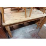 A 4' 6" waxed pine farmhouse style kitchen table, set on turned legs