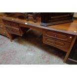 A 4' 11" late 20th Century knee-hole dressing table with four flanking drawers, set on faceted lags
