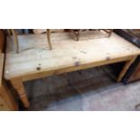 A 6' waxed pine farmhouse kitchen table with thick sectional top and drawer to one end, set on
