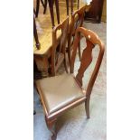 A set of four walnut framed Queen Anne style dining chairs with upholstered drop-in seats, set on