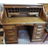 A 4' 2"early 20th Century H. L. L. polished oak roll-top desk with tambour enclosing a fitted