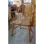 A pair of 20th Century wheel back elbow chairs with solid elm seat panels, set on simple turned