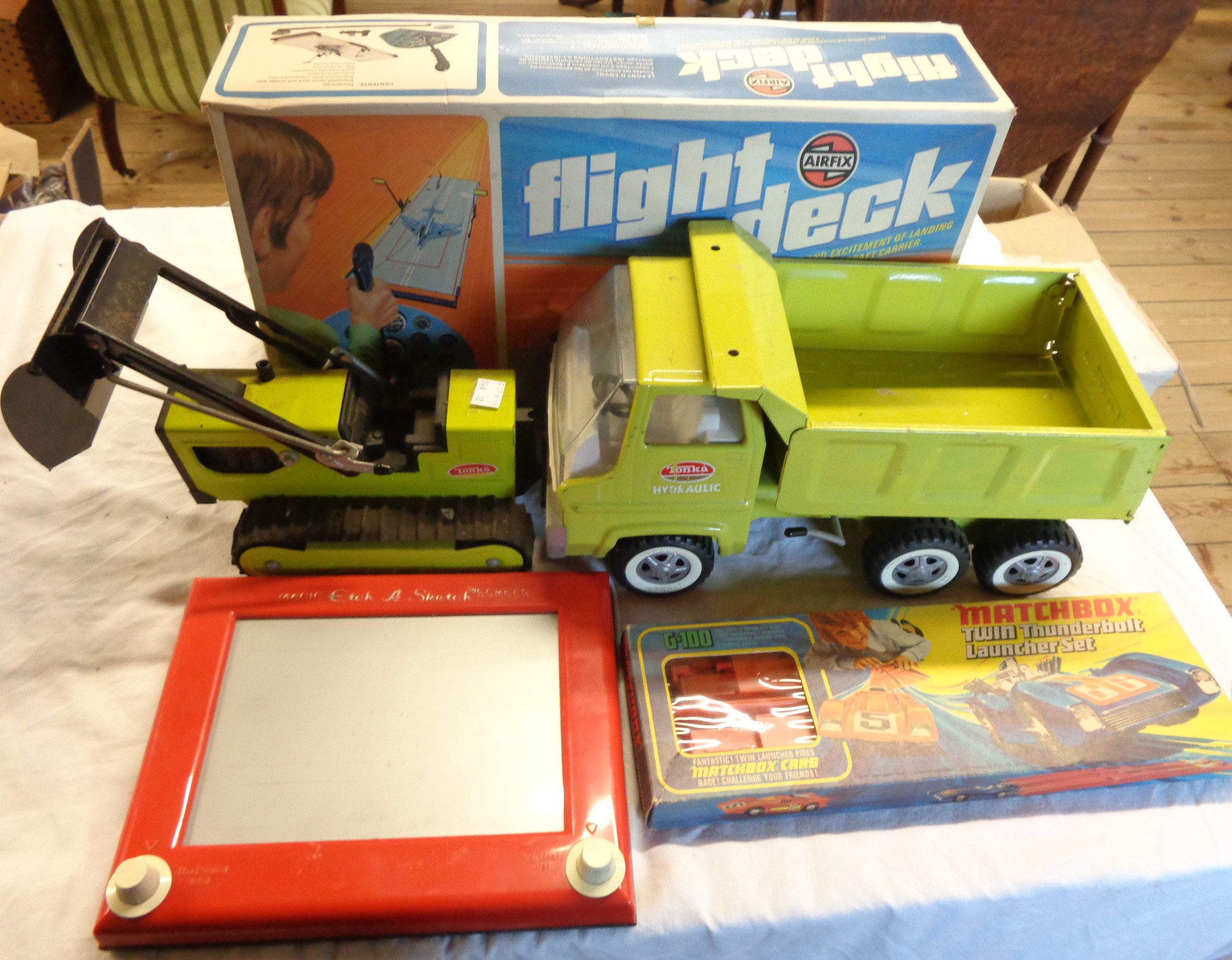 A collection of toys and games including Airfix Flight Deck, Matchbox Twin Thunderbolt Launcher,