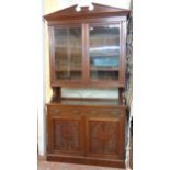 A 4' Edwardian walnut two part book cabinet with moulded cornice and adjustable shelves enclosed