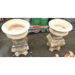 A pair of garden urns on plinth bases - one urn a/f