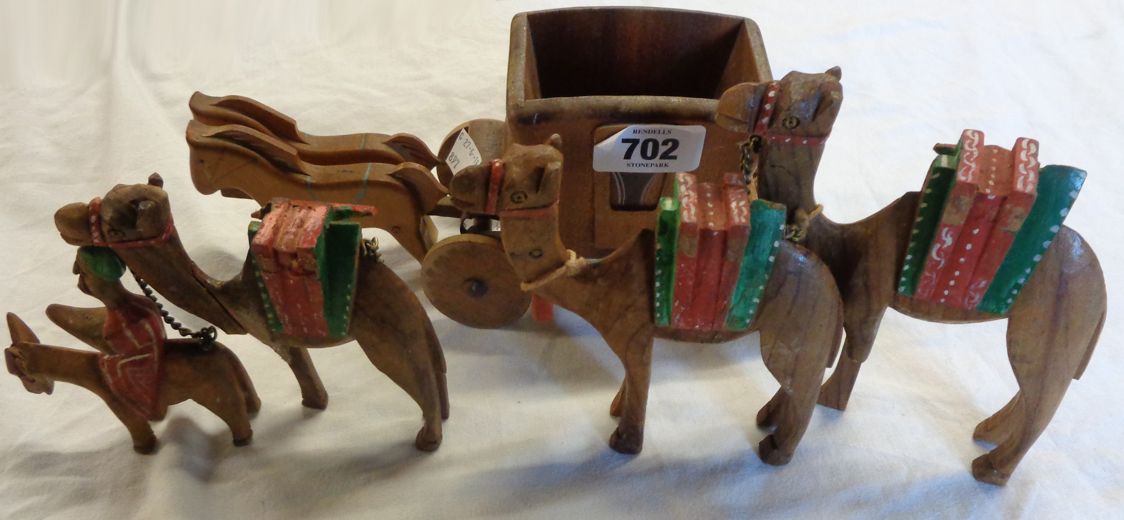 A small wooden coach and horses - sold with a carved wooden camel train (a/f)