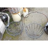 A pair of wrought iron hanging/standing baskets