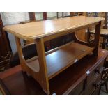 A 35 1/2" retro teak effect two-tier coffee table, set on open standard ends