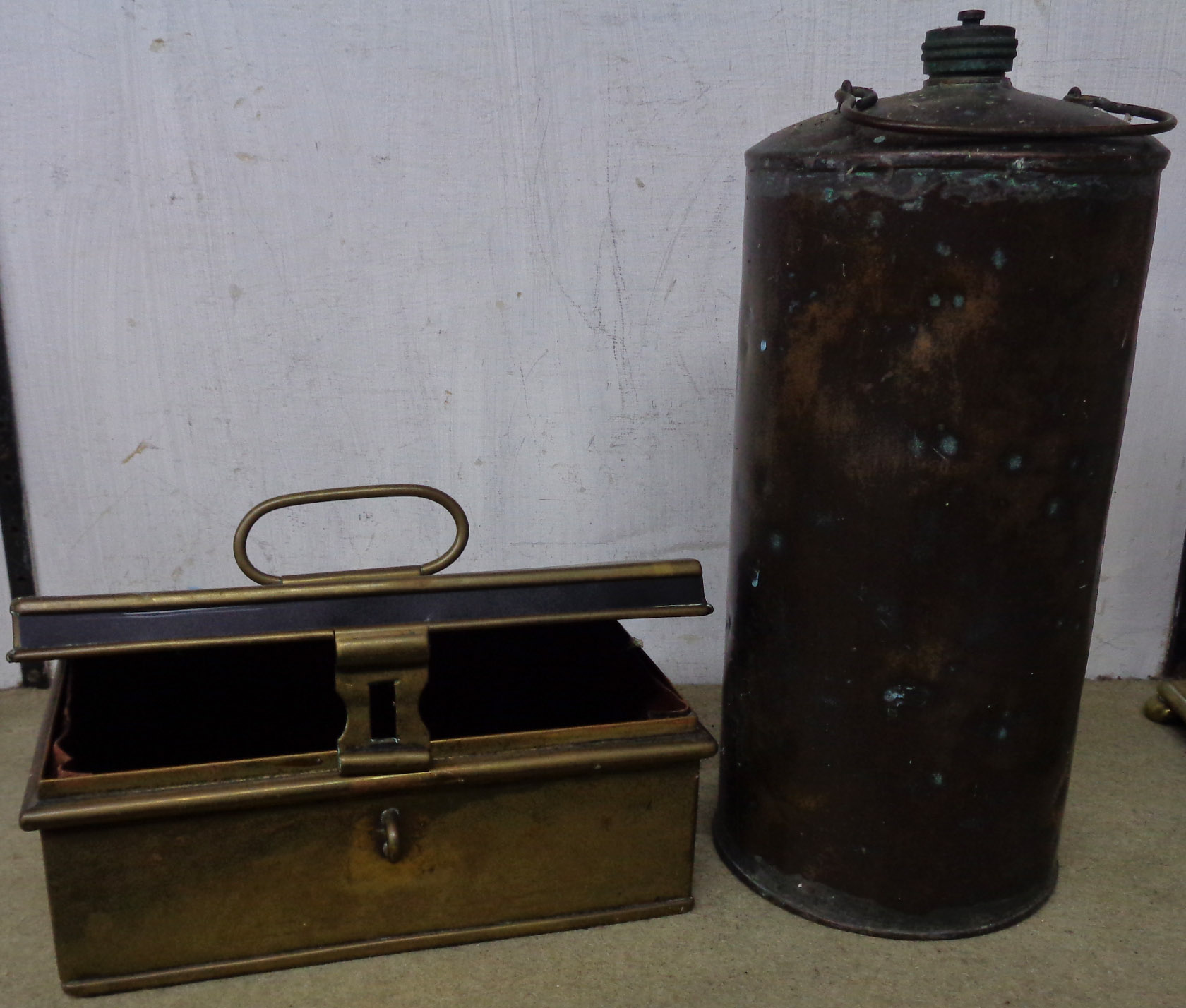 A copper cash tin and a copper hot water bottle with release valve lid
