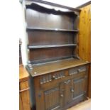 A 3' 6" polished oak two part dresser by L. Marcus Ltd. with two shelf open plate rack over a