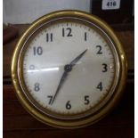 A brass bulkhead style cased clock with alarm movement