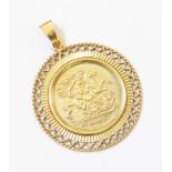 A hallmarked 375 gold pendant with Sovereign style centre within a pierced border