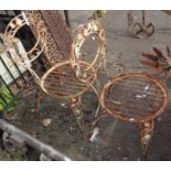 Two vintage metal spoon back garden chairs with floral decoration