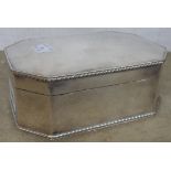 A 6 1/4" silver plated octagonal shaped biscuit box with hinged lid and cast borders