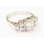 A marked 375 white metal Art Deco style stepped ring set with cubic zircona stones