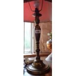 A brass table candlestick pattern lamp with shade