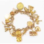 A marked 9ct. fancy-link charm bracelet, set with a selection of 9ct. and yellow metal charms