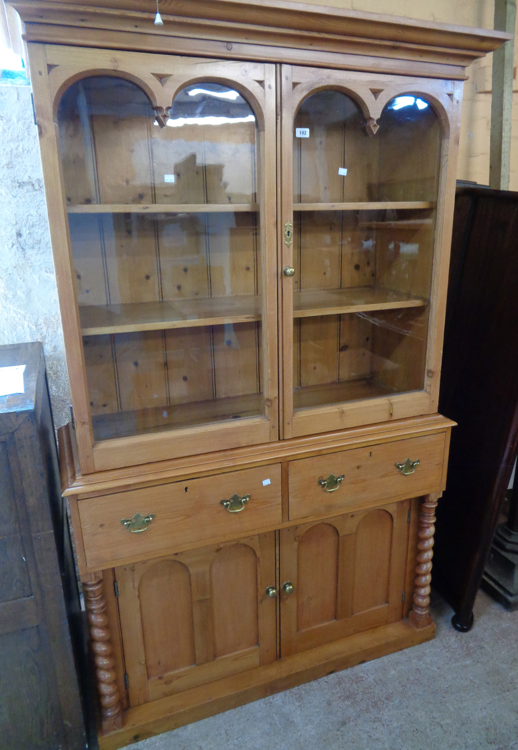 A 48 1/2" Victorian waxed pine two part dresser with moulded cornice and Gothic style detailing to