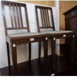 A pair of Edwardian inlaid walnut slat-back bedroom chairs with upholstered seat panels, set on