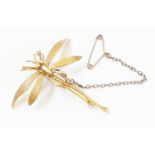 A 1 3/4" wingspan unmarked yellow metal dragon fly pattern brooch, with later safety chain