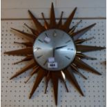 A Metamec polished wood and brassed metal framed sunburst wall timepiece with battery movement