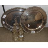 A silver plated oval meat tray, breadboard base and a four bottle cruet on stand