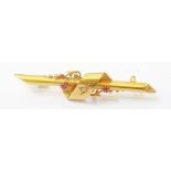 A cased Victorian 15ct. gold bar brooch, set with tiny diamond and flanking rubies