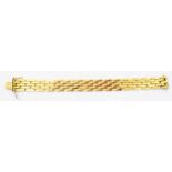 A marked 750 yellow metal brick-link bracelet