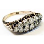 A Victorian marked "18" yellow metal ring, set with two rows of old cut diamonds in a boat shaped