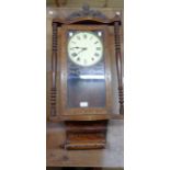 A late 19th Century American inlaid walnut cased wall clock with visible mercury style pendulum