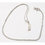 An Italian marked 750 white metal pendant, set with two baguette diamonds, on marked 750 chain