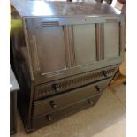 A 30" 20th Century stained oak bureau with part fitted interior and three long graduated drawers