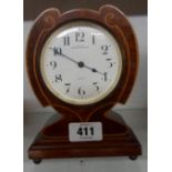 An Art Nouveau inlaid mahogany cased timepiece with French eight day movement - retailed by Waring &