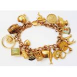 A 9ct. rose gold kerb-link charm bracelet, set with a selection of 9ct. and other yellow metal