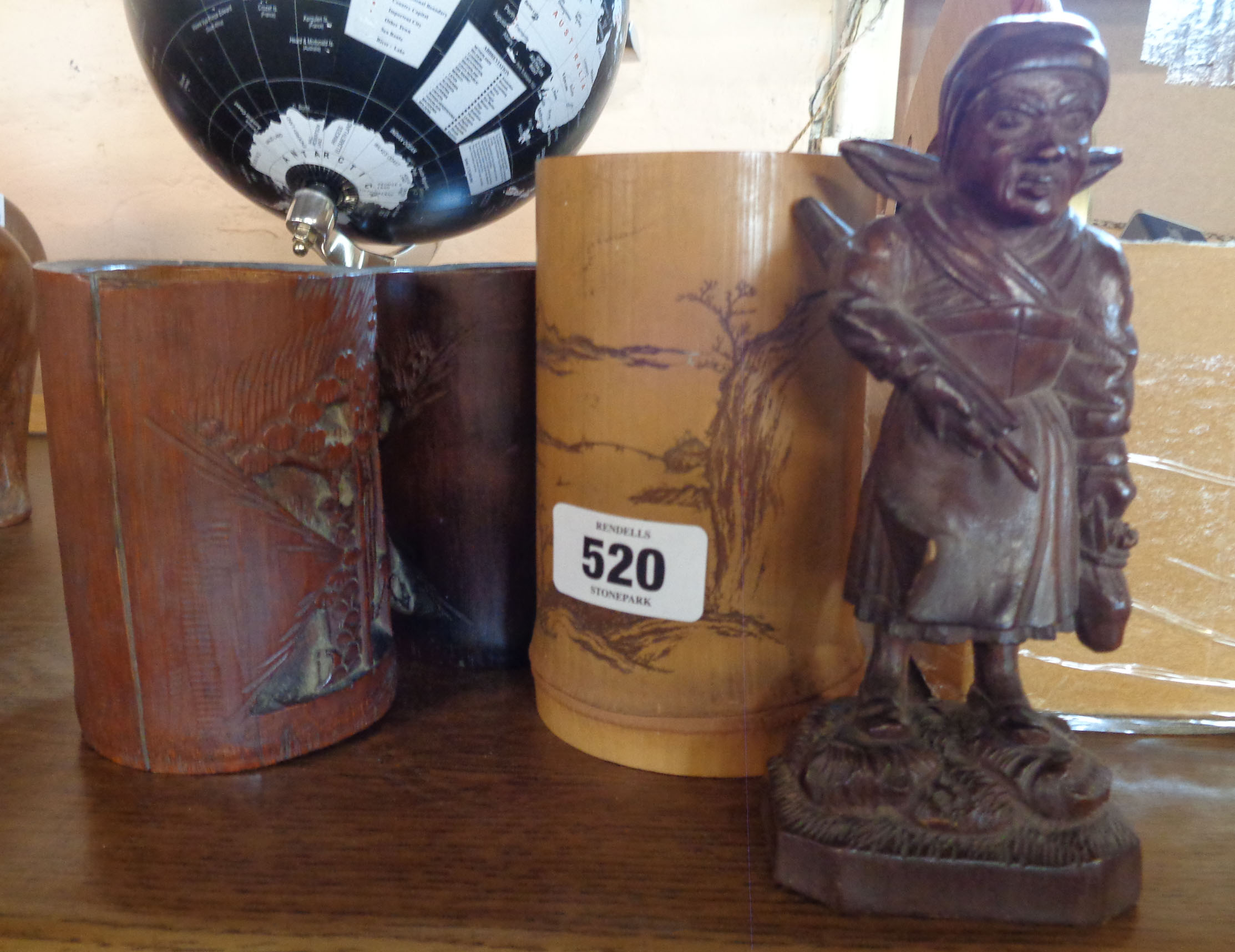 Three Oriental brush pots and carved wood figure