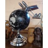 A modern Art Deco style black and white globe with stylized aeroplane to top