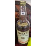 A large vintage Bells whisky bottle