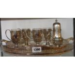 A silver plated oval gallery tray with four pedestal cups and sugar caster