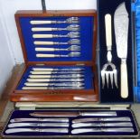 An early 20th Century mahogany cased set of six each silver plated fish knives and forks - sold with