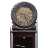 An early 20th Century German oak longcase clock, the 10 1/2" diameter painted dial with floral