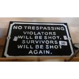 A modern cast iron Trespass sign