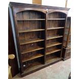 A 5' 3 1/4" stained pine open bookcase with moulded cornice, applied mask and two sets of five