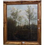 An ornate gilt framed oil on canvas, depicting figures on a woodland track with chapel in background