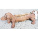 A cast-iron dachshund pattern boot scraper