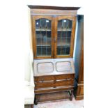 A 3' 2 1/4" early 20th Century polished oak bureau bookcase with shelves enclosed by a pair of