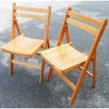 Two wooden slatted folding chairs