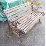 A garden bench with cast iron ends and slatted wood seat - length 4' 2"