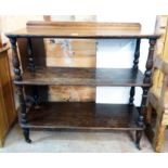 A 3' 6" Edwardian polished oak three tier buffet with turned supports, set on brown porcelain