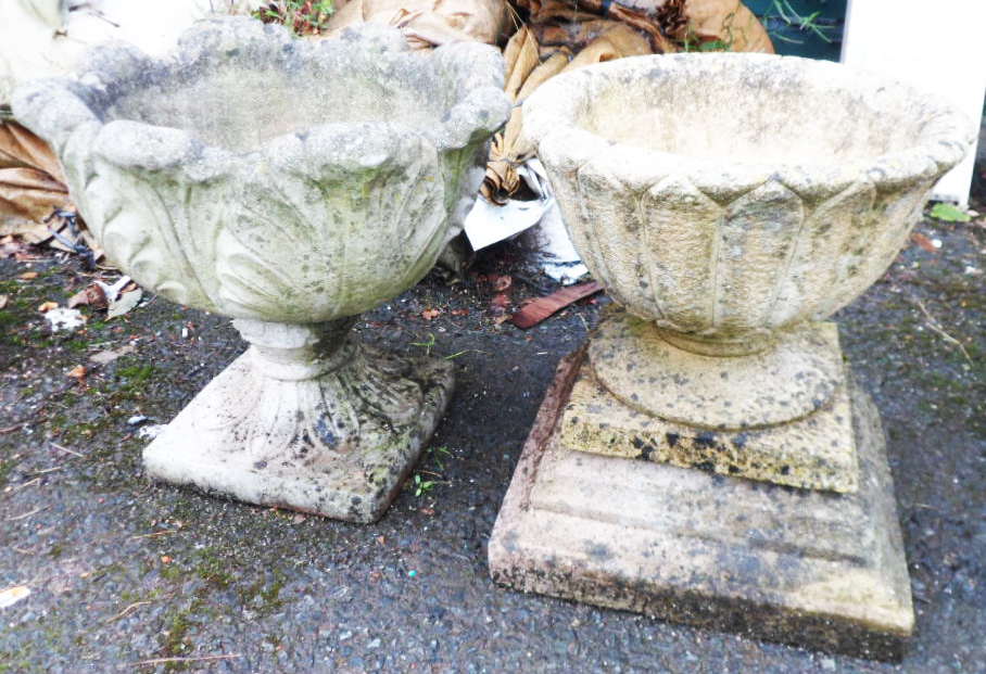 A pre-cast garden urn on plinth with acanthus decoration - sold with another