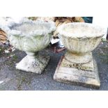 A pre-cast garden urn on plinth with acanthus decoration - sold with another